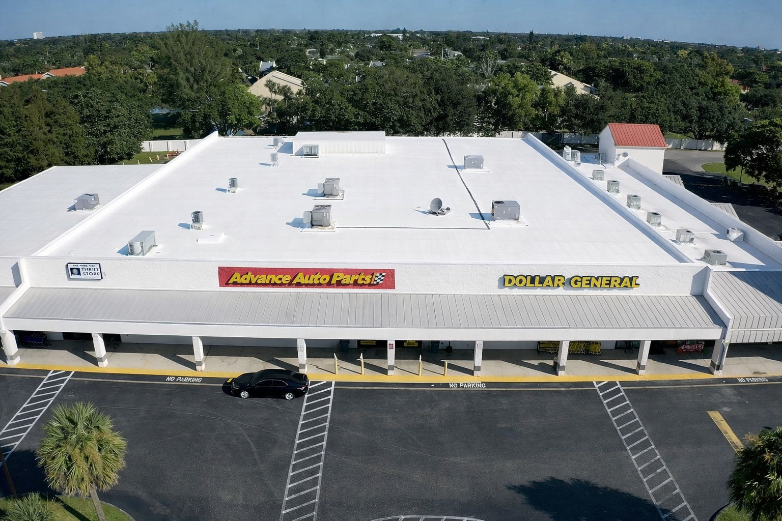Ocean Group Construction — TPO roof on multi-tenant retail shopping center with Advance Auto Parts and Dollar General